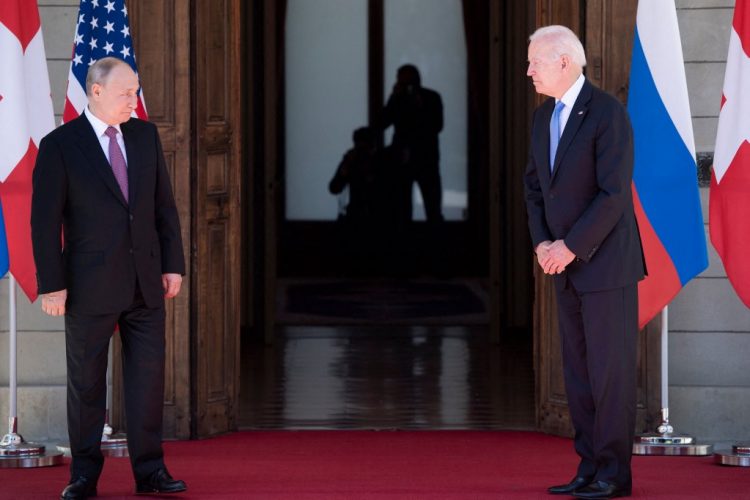 Russian President Vladimir Putin (L) looks on next to US President Joe Biden prior to the US-Russia summit at the Villa La Grange, in Geneva on June 16, 2021. (Photo by Brendan Smialowski / AFP)