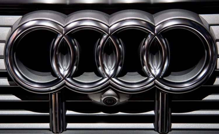 (FILES) In this file photo taken on May 14, 2019 an Audi logo is seen on the radiator grill of an Audi e-tron electric car on display at the annual general meeting of German car manufacturing giant Volkswagen in Berlin. - German luxury carmaker Audi said on June 22, 2021 it will stop manufacturing diesel and petrol cars by 2033 as part of an industry-wide pivot towards more environmentally friendly electric cars. (Photo by John MACDOUGALL / AFP)