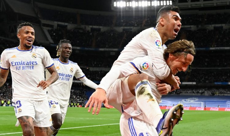 El centrocampista croata del Real Madrid Luka Modric (R) celebra con sus compañeros de equipo después de marcar un gol durante el partido de fútbol de la liga española entre el Real Madrid CF y la Real Sociedad. (Photo by PIERRE-PHILIPPE MARCOU / AFP)