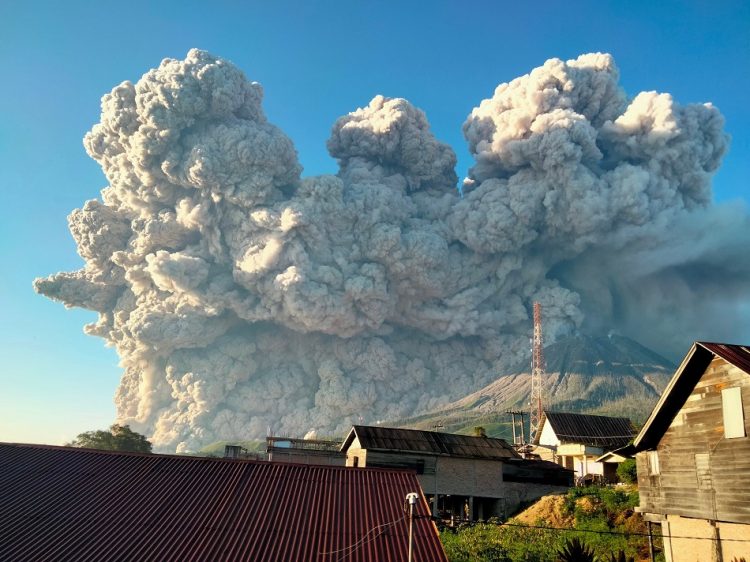 Mount Sinabung spews some 5,000-metre-high of hot ash into the sky seen from Karo, North Sumatra on March 2, 2021. (Photo by Sastrawan Ginting / AFP)