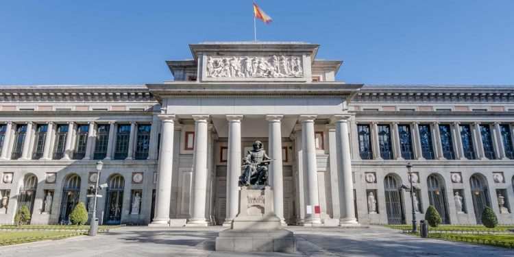 Prado Museum facade and Cervantes statue in Madrid, Spain