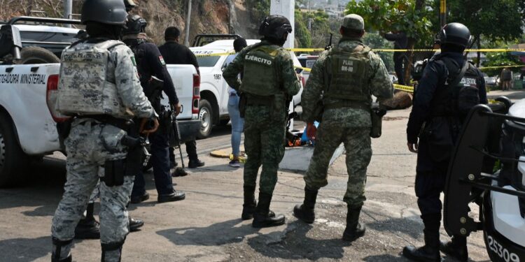 Members of the National Guard and soldiers of the Mexican Army stand guard at the site where the PRI candidate for mayor of Coyuca de Benitez, Anibal Zuniga Cortes, and his wife, Ruby Bravo, were killed in Acapulco, Guerrero state, Mexico, on May 16, 2024. A local politician and his wife were murdered in Mexico's Pacific coastal resort of Acapulco, his party said Friday -- the latest victims of a wave of electoral violence. The Institutional Revolutionary Party (PRI) said Anibal Zuniga was standing in the June 2 elections to be a councilor in the municipality of Coyuca de Benitez in Guerrero state (Photo by FRANCISCO ROBLES / AFP)