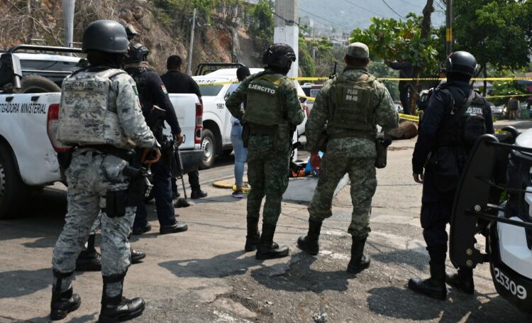 Members of the National Guard and soldiers of the Mexican Army stand guard at the site where the PRI candidate for mayor of Coyuca de Benitez, Anibal Zuniga Cortes, and his wife, Ruby Bravo, were killed in Acapulco, Guerrero state, Mexico, on May 16, 2024. A local politician and his wife were murdered in Mexico's Pacific coastal resort of Acapulco, his party said Friday -- the latest victims of a wave of electoral violence. The Institutional Revolutionary Party (PRI) said Anibal Zuniga was standing in the June 2 elections to be a councilor in the municipality of Coyuca de Benitez in Guerrero state (Photo by FRANCISCO ROBLES / AFP)
