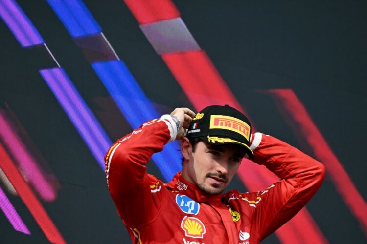 Third-placed Ferrari's Monegasque driver Charles Leclerc poses on the podium of the Emilia Romagna Formula One Grand Prix at the Autodromo Enzo e Dino Ferrari race track in Imola on May 18, 2024. (Photo by ANDREJ ISAKOVIC / AFP)