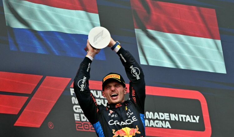 Race winner Red Bull Racing's Dutch driver Max Verstappen holds his trophy on the podium of the Emilia Romagna Formula One Grand Prix at the Autodromo Enzo e Dino Ferrari race track in Imola on May 18, 2024. (Photo by ANDREJ ISAKOVIC / AFP)