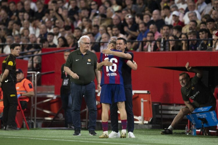 Barcelona's Spanish midfielder #16 Fermin Lopez celebrates scoring a goal with Barcelona's Spanish coach Xavi Hernandez during the Spanish league football match between Sevilla FC and FC Barcelona at the Ramon Sanchez Pizjuan stadium in Seville on May 26, 2024. (Photo by JORGE GUERRERO / AFP)