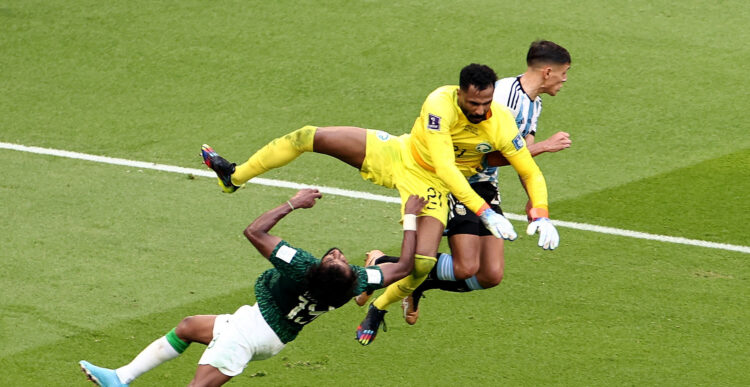 Soccer Football - FIFA World Cup Qatar 2022 - Group C - Argentina v Saudi Arabia - Lusail Stadium, Lusail, Qatar - November 22, 2022  Argentina's Nahuel Molina in action as Saudi Arabia's Mohammed Al-Owais collides into Yasser Al-Shahrani REUTERS/Marko Djurica     TPX IMAGES OF THE DAY