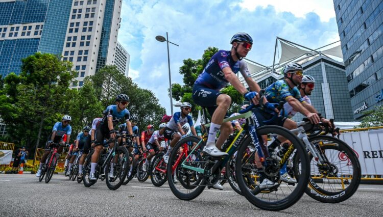 Riders take part in the second Tour de France Singapore Criterium race in Singapore on October 29, 2023. (Photo by Roslan RAHMAN / AFP)
