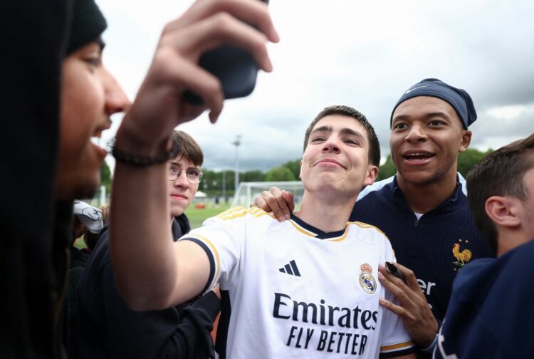 Kylian Mbappé posó con un aficionado del Real Madrid en la concentración de la selección francesa. Foto AFP
