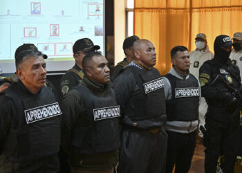 Military (L to R) Roberto ArgandoÒa, Raul Barbery, Marcelo Gutierrez, and Franz Luis OrdoÒez are escorted by policemen following their arrest, accused of being accomplices of now-dismissed army chief General Juan Jose Zuniga, after he led a military movement that attempted to seize the government palace by force in La Paz on June 27, 2024.††. Bolivian President Luis Arce was facing a deep political crisis on Thursday after a botched bid by military chiefs to overthrow his government deepened turmoil in a country facing severe economic decline. (Photo by AIZAR RALDES / AFP)